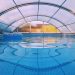 Blue swim ring floating in a covered swimming pool filled with clear blue water